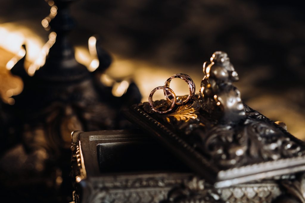 Gold Wedding Rings Lie On An Antique Jewelry Box. Wedding Rings For Ceremonies